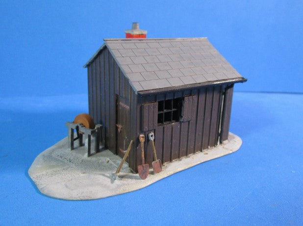 UB058 Workman's hut with grinding wheel